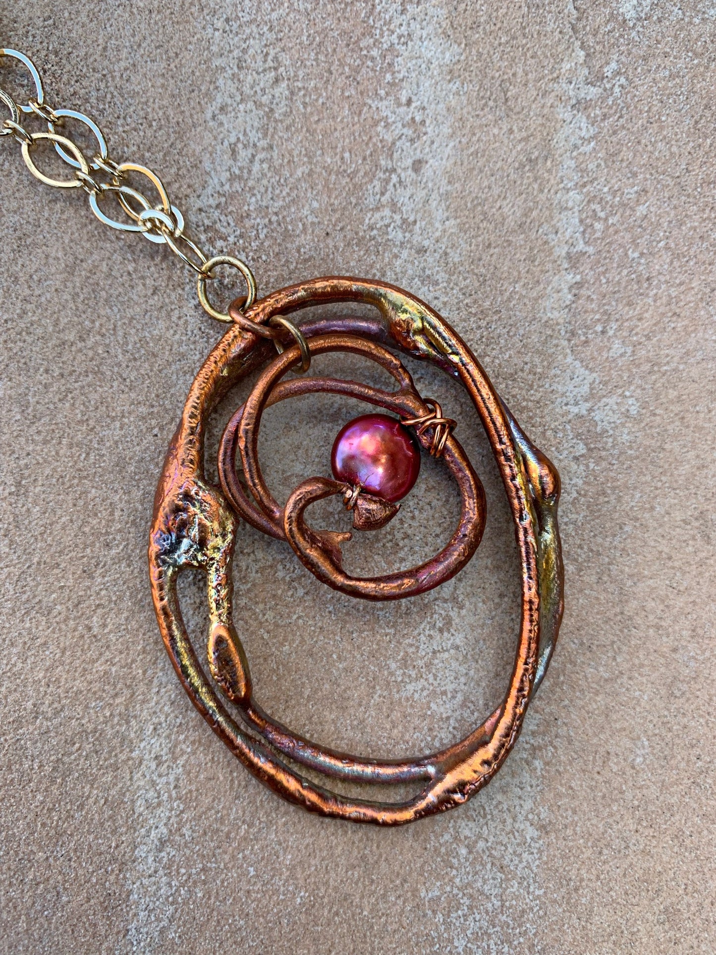 Copper pendant on gold chain necklace