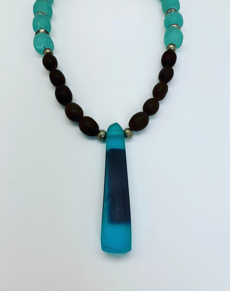African glass with brown seeds and resin pendant