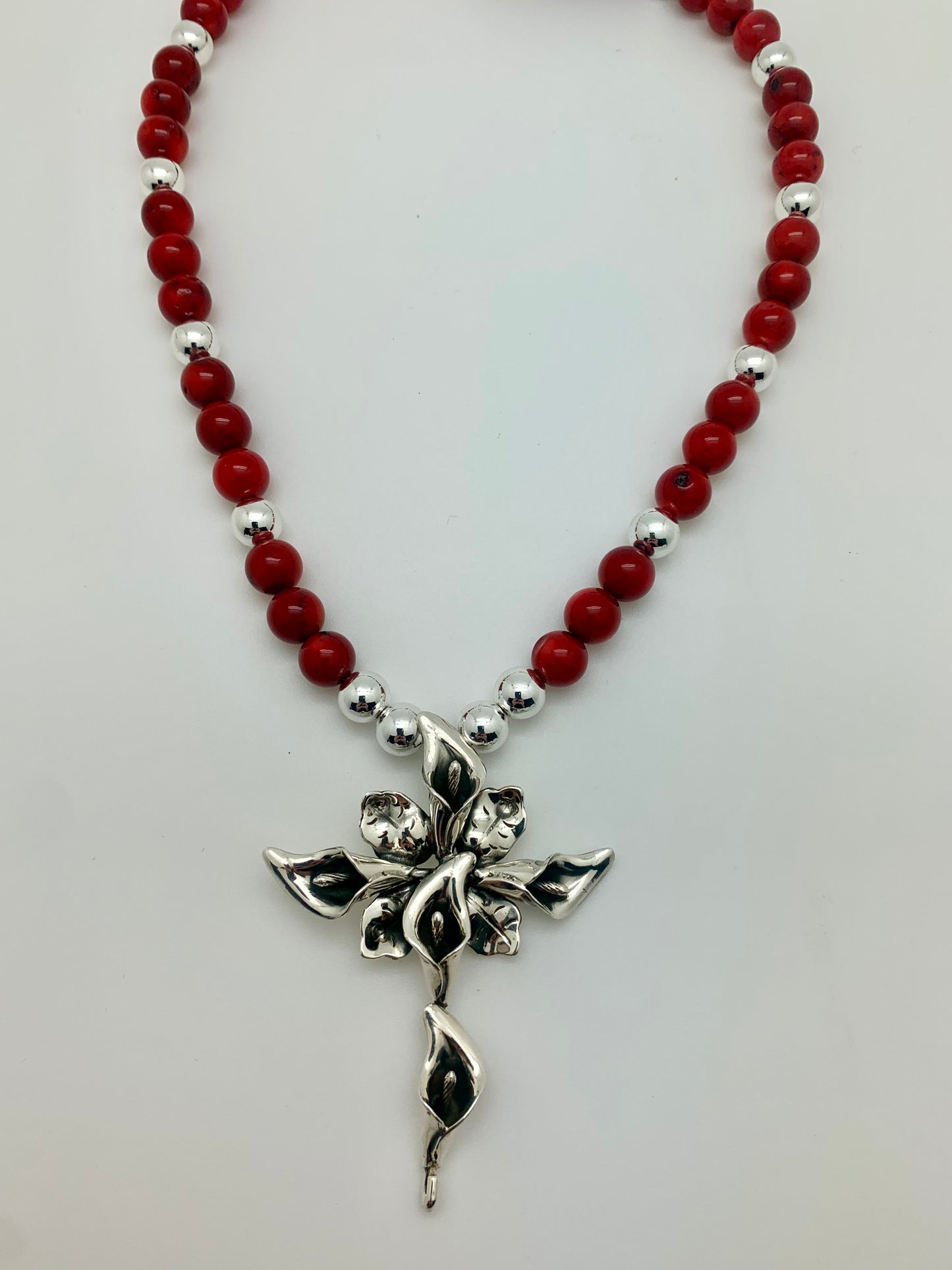 Sterling silver lily cross on red coral with hematite silver beads