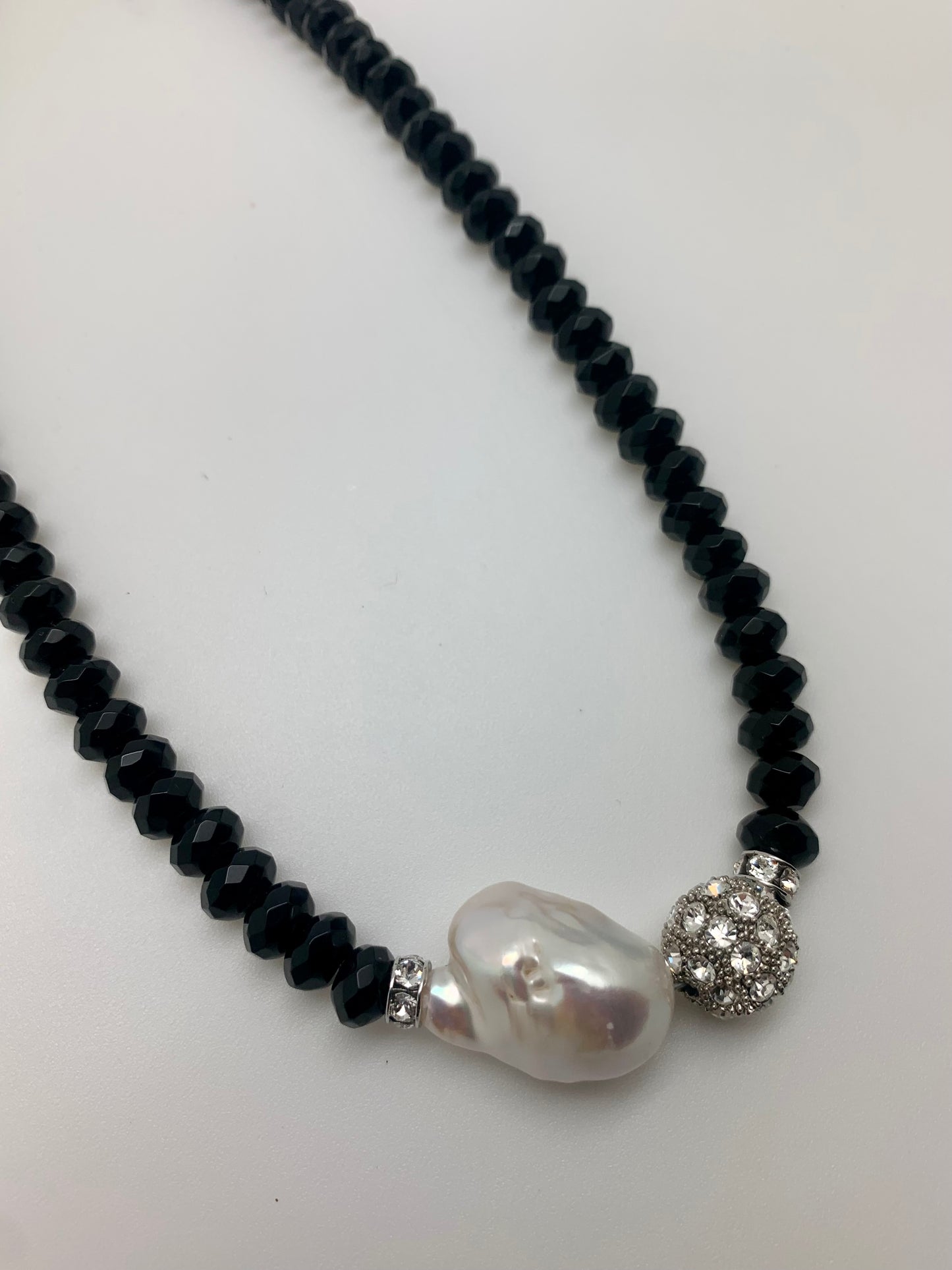 Faceted black onyx with baroque pearl and crystal bead