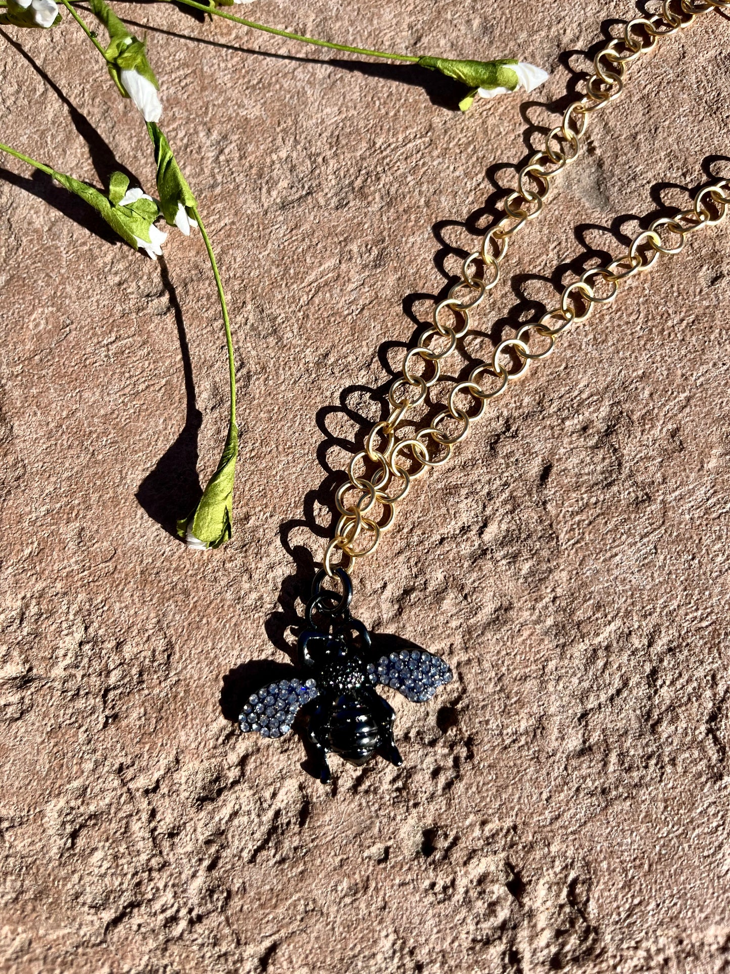 Gold chain with black bee
