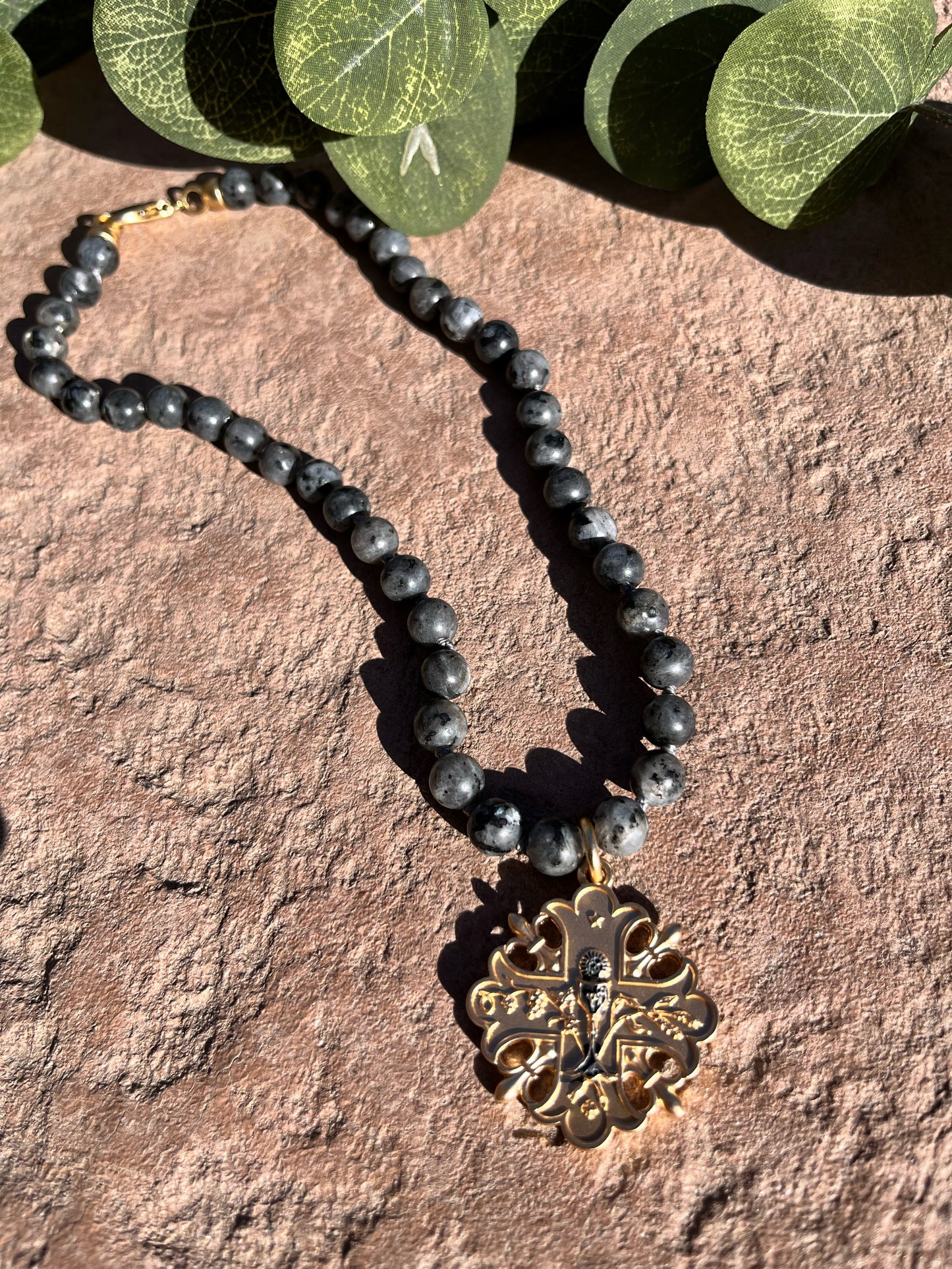 Black beads with gold cross
