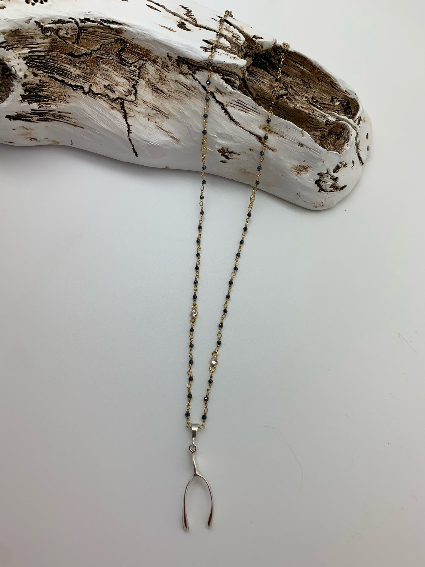 Gold chain with blue and white crystals with wishbone