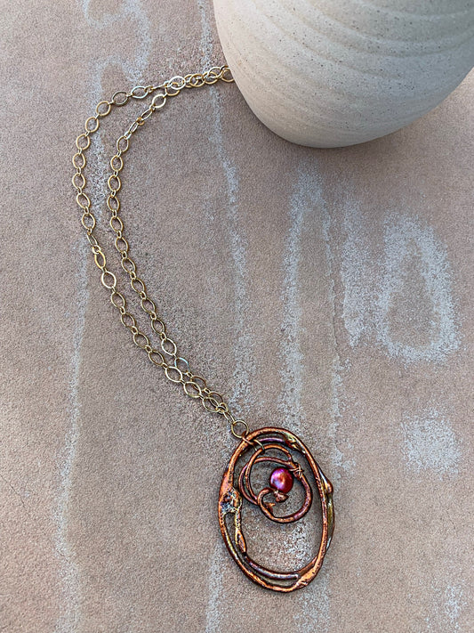 Copper pendant on gold chain necklace