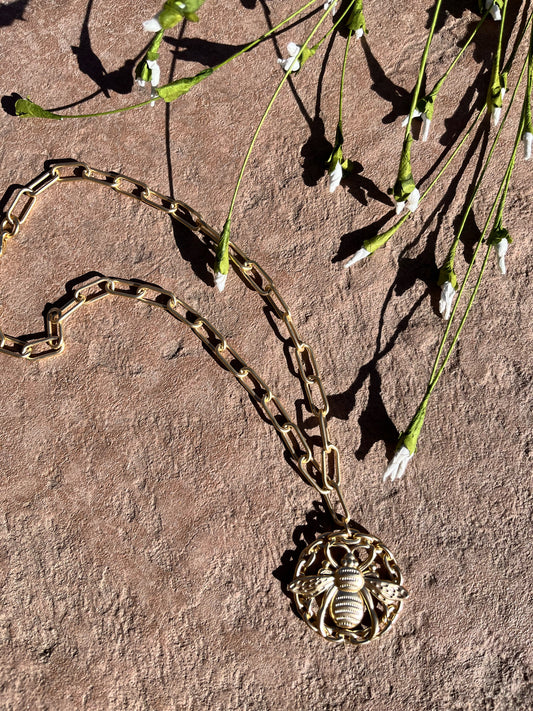 Gold chain with large round bee pendant