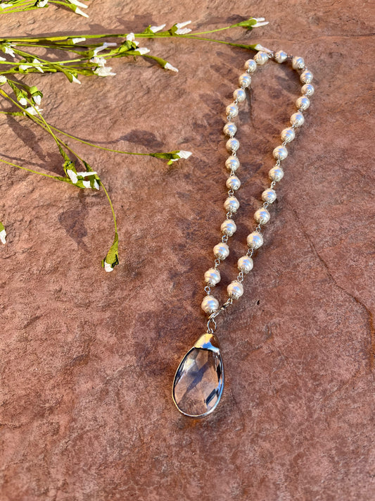 Pearl strand with crystal teardrop